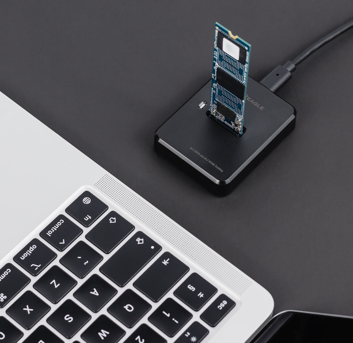SSD M.2 umieszczony w zewnętrznym adapterze Reagle RY5M2 obok laptopa