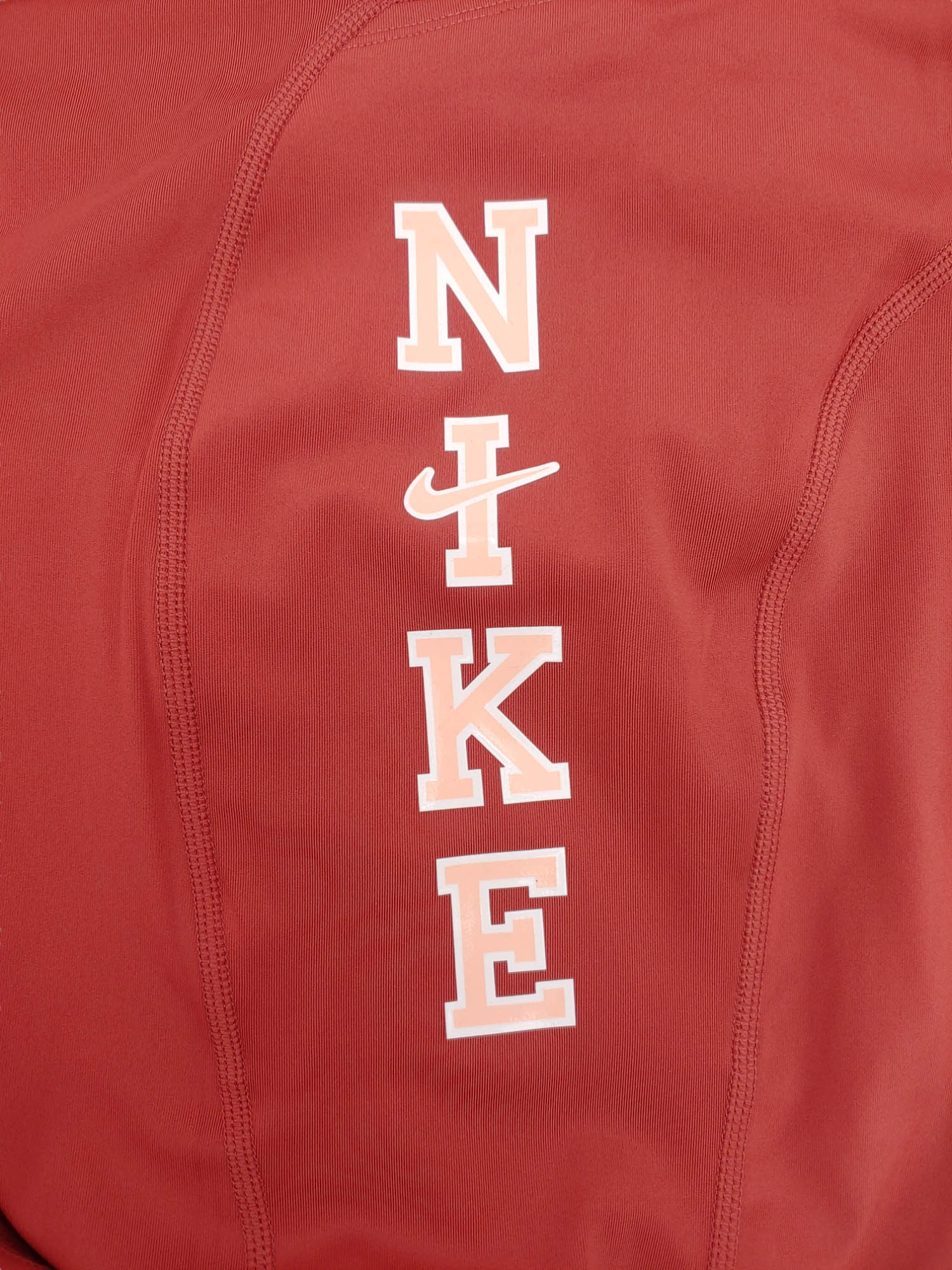 Damskie brązowe legginsy Nike Fast 7/8 DV4891-691 3X tył z kieszenią na zamek