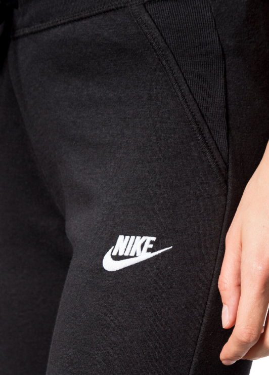 Czarne damskie spodnie dresowe Nike Sportswear Fleece Slim Fit 807364-010 L bok z wąskimi nogawkami