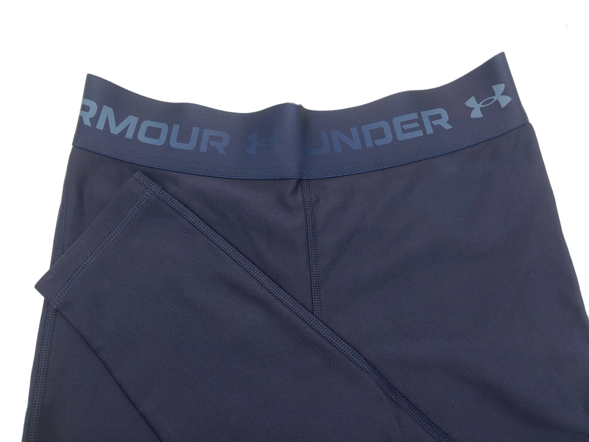 Damskie granatowe legginsy Under Armour HeatGear 1361043-410 SM bok z minimalistycznym designem