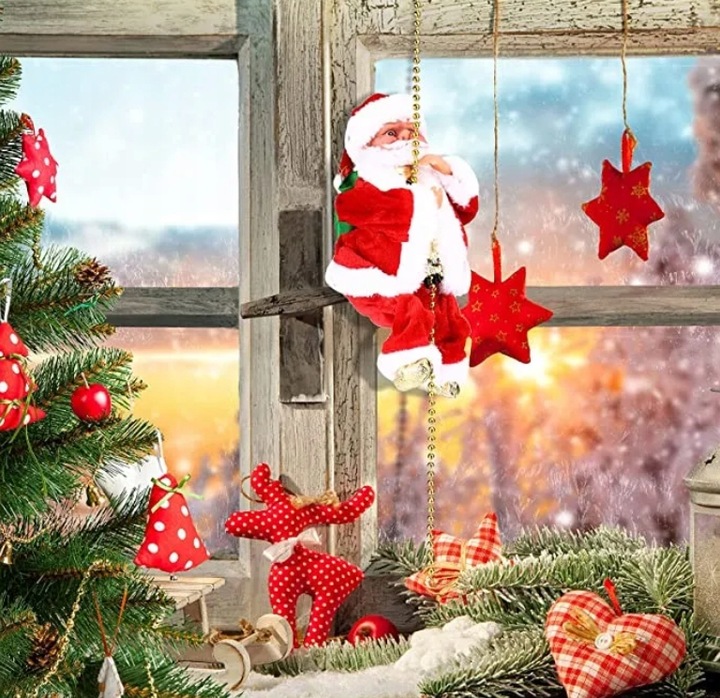 WSPINAJĄCY SIĘ MIKOŁAJ GRA ŚPIEWA ŚWIECI ŚWIĘTA NA PREZENT