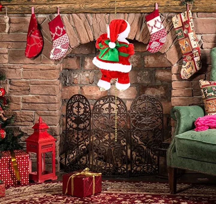 WSPINAJĄCY SIĘ MIKOŁAJ GRA ŚPIEWA ŚWIECI ŚWIĘTA NA PREZENT