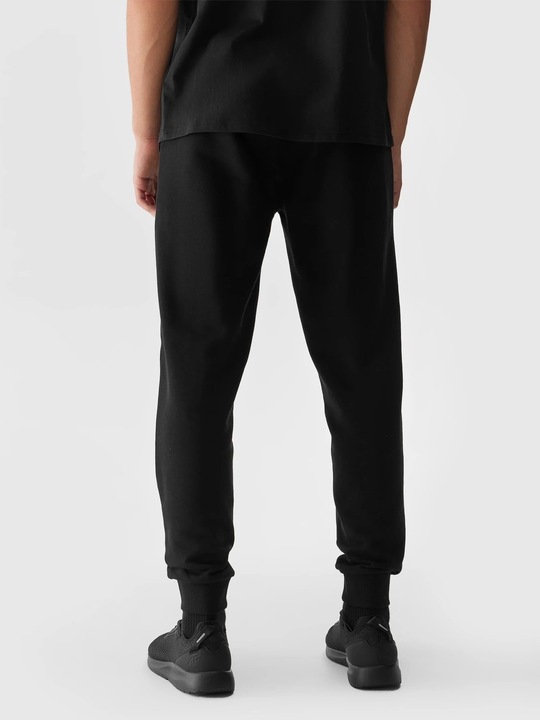 Spodnie dresowe męskie 4F czarne - 4FWSS24TTROM603